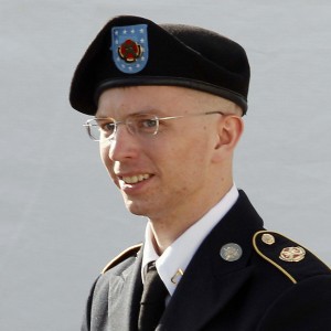 Army Private First Class Manning is escorted in handcuffs as he leaves the courthouse in Fort Meade