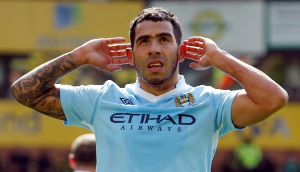 Tevez of Manchester City celebrates, gesturing towards Norwich City fans, after scoring his second goal against them in their English Premier League soccer match in Norwich