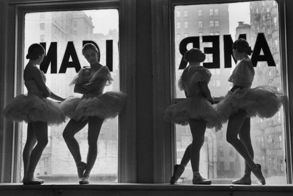 Ballerinas standing on window sill in rehearsal room at