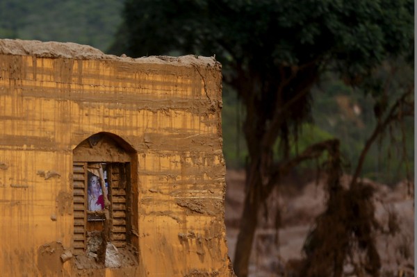 The window of a damaged house is pictured in Bento Rodrigues district after a dam, owned by Vale SA and BHP Billiton Ltd burst, in Mariana