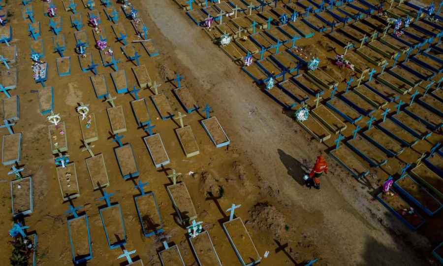 Vista aérea de um coveiro caminhando entre os túmulos de vítimas da Covid-19 no cemitério de Nossa Senhora Aparecida em Manaus, estado do Amazonas, Brasil, em 29 de abril de 2021.