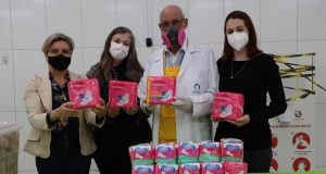 Padre Julio em foto mostrando absorventes higiênicos para mulheres