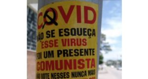 Cartaz sobre Covid-19 em poste