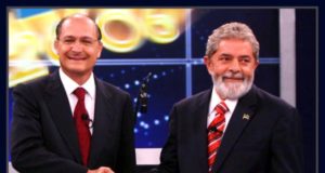 Lula e Alckmin se cumprimentando com um aperto de mãos