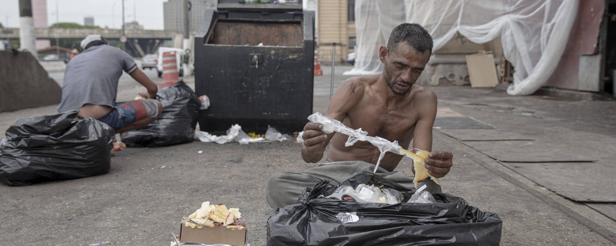 Reginaldo Gonçalves da Silva, de 41 anos, separa comida que iria para o lixo, em São Paulo. Danilo Verpa/Folhapress