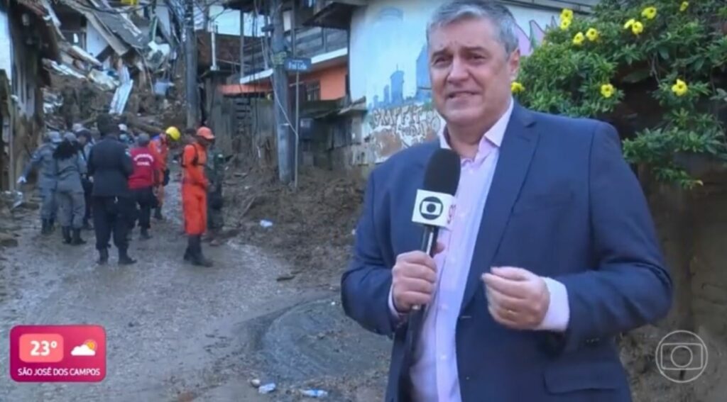 Flávio Fachel na rua, com o microfone da Globo na mão chorando ao mostrar trabalho dos bombeiros em Petrópolis.