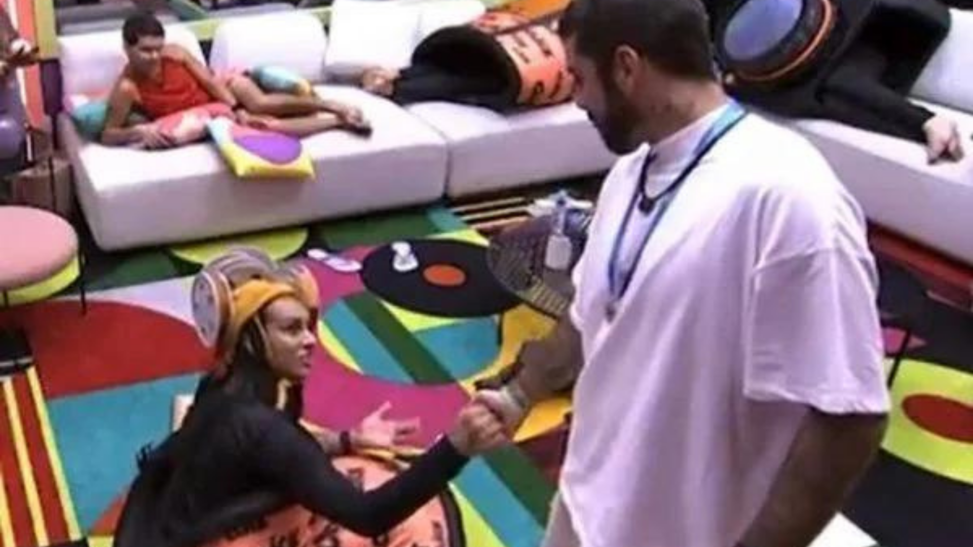 Pedro Scooby é acusado de transfobia. Na foto ele fala com uma participante dentro de quarto do BBB 22.