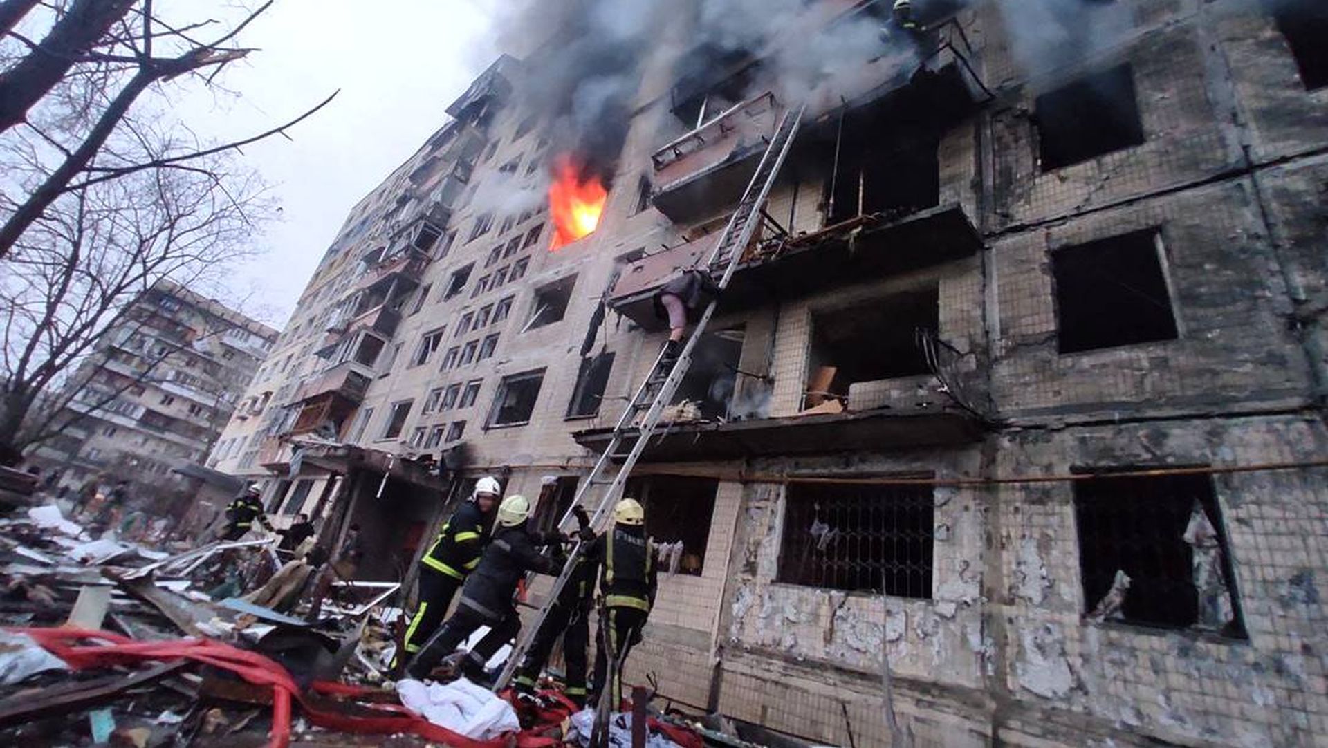 Bombeiros combatem incêndio em um prédio atingido por bombardeio aéreo russo, no bairro de Obolon, em Kiev 