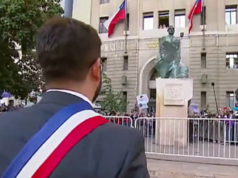 Gabriel Boric saúda estátua de Allende. ele aparece de costas para a câmera e em frente à estátua de Allende.