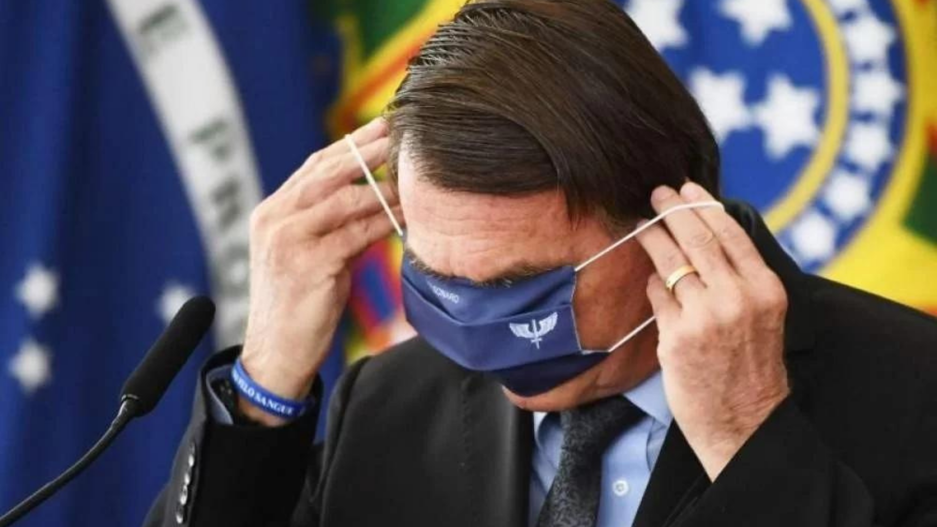 Presidente Bolsonaro com uma máscara de proteção cobrindo os olhos.