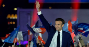 Foto de Emmanuel Macron acenando para o público enquanto comemora a vitória nas eleições.