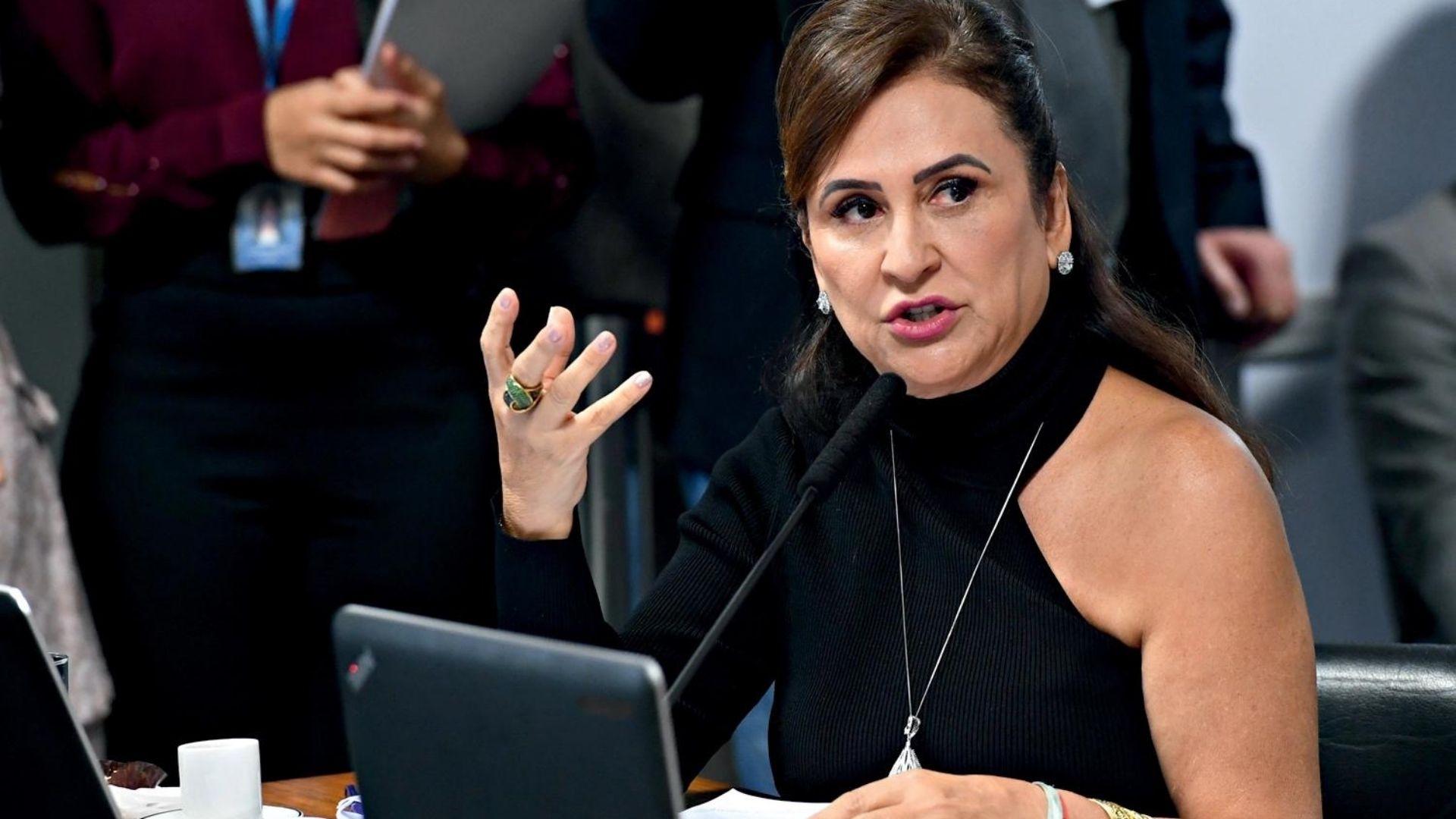 Foto da senadora Kátia Abreu com vestido preto e gesticulado com a mão direita.