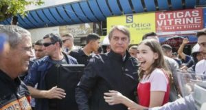 Foto de Bolsonaro com camisa preta ao lado de apoiadores.