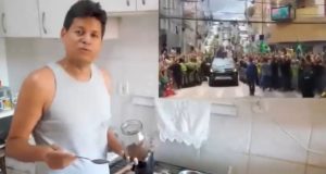 Daniel Sucupira de camiseta cinza na cozinha de casa, falando para a câmera, com vídeo de Bolsonaro ao lado
