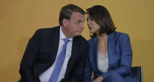 jair e Michelle Bolsonaro sentados, cochichando