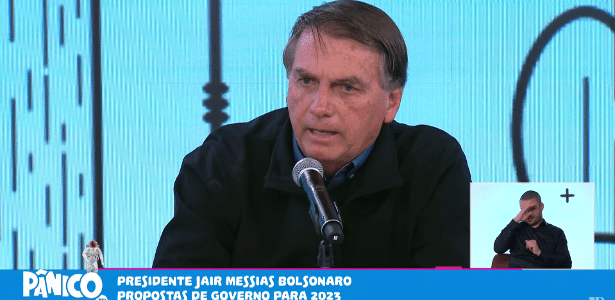 Jair Bolsonaro de roupa preta no estúdio do Pânico, da Jovem Pan