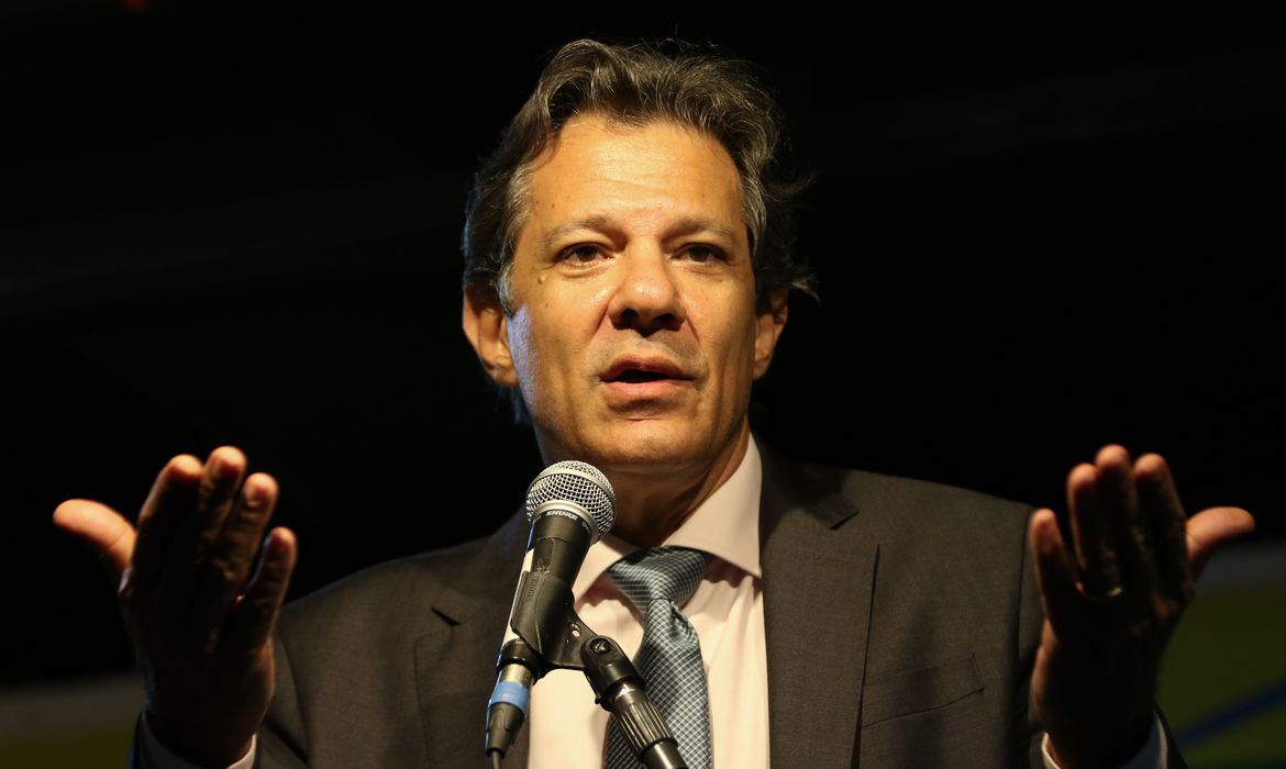 Fernando Haddad falando e gesticulando com expressão séria