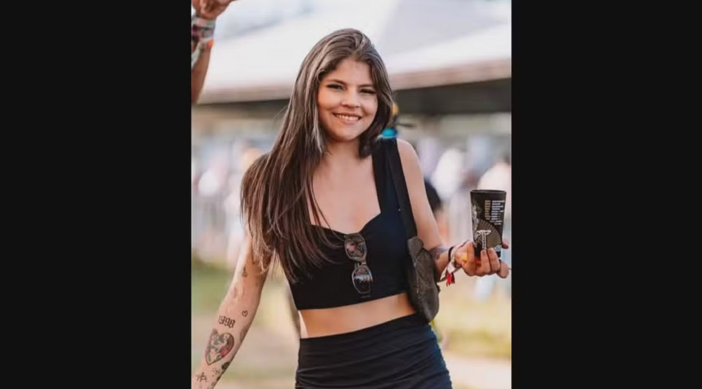 Mariane Silva Torres de roupa preta, sorrindo, de cabelo solto