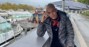 Yuri Henrique Gabriel Santos de Castro posando sério, de roupa de frio, perto de barcos