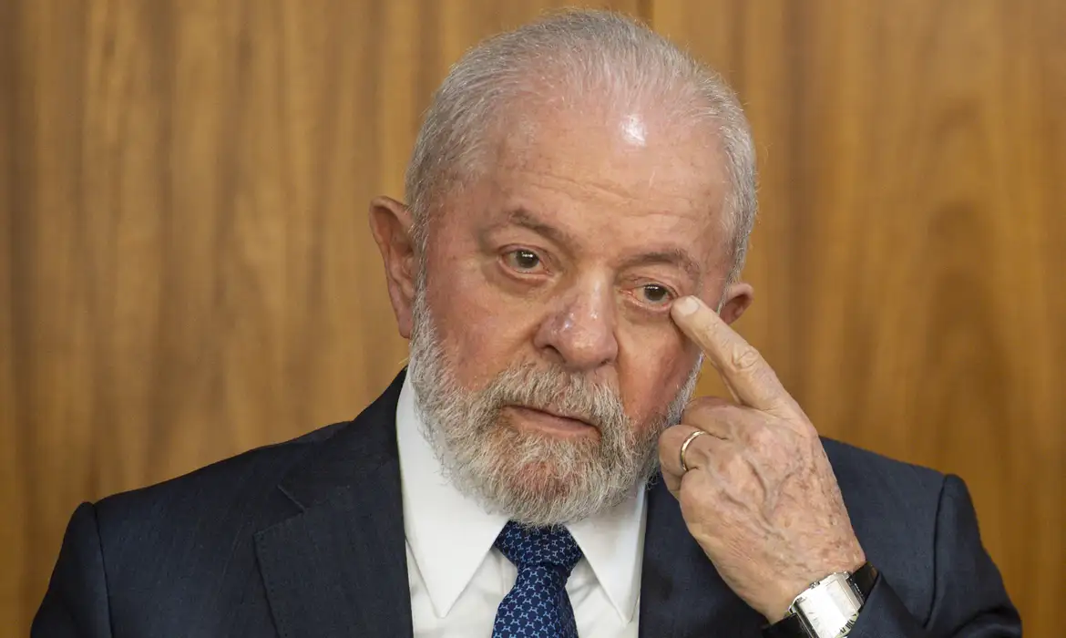 Lula com expressão desconfiada e mão perto de olho