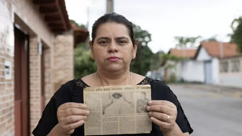 Cenilda Gomes e o recorte de jornal com a foto de sua irmã, Cejane, e a notícia do crime