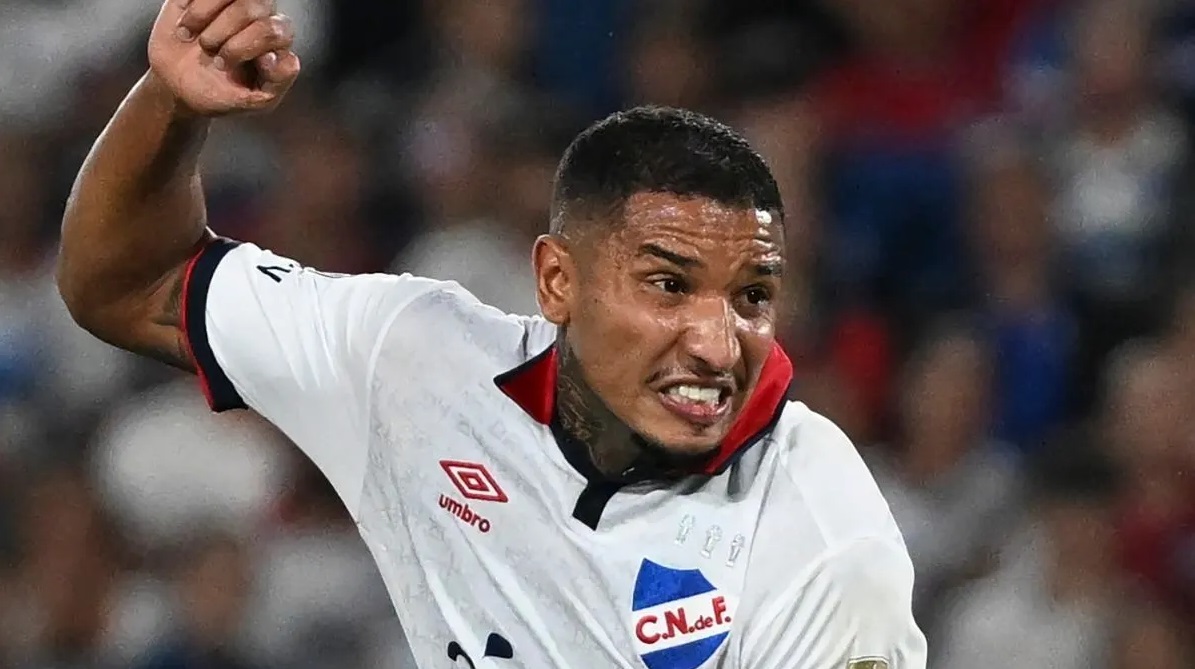 O zagueiro Juan Izquierdo em campo, gritando, correndo, com braço levantado