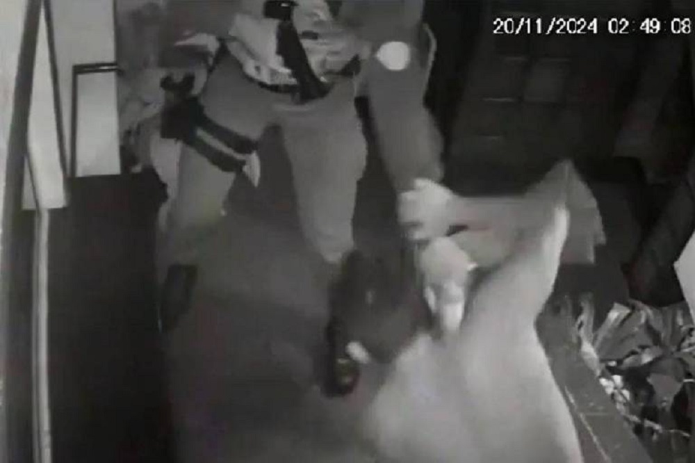 Imagem de câmera de segurança de policial e estudante em luta corporal