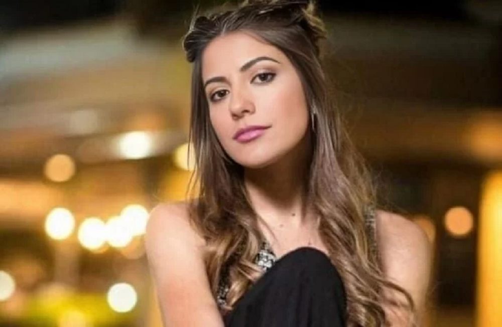 A ex-panicat Ana Paula Leme posando sem sorrir, de roupa preta, olhando para a câmera