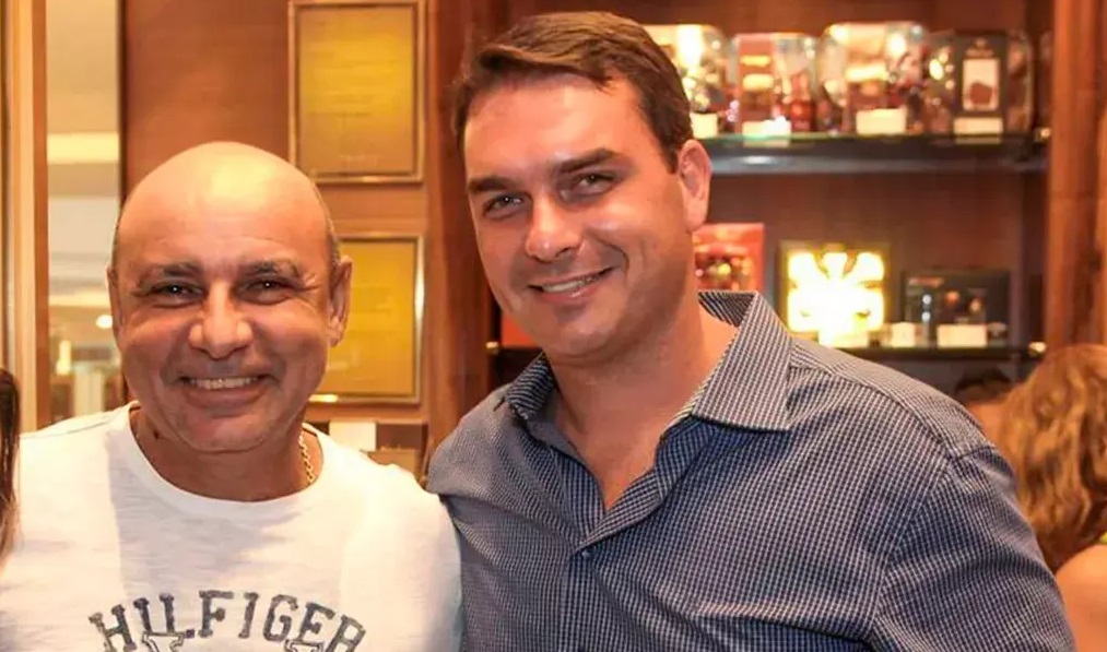 Fabrício Queiroz e Flávio Bolsonaro sorrindo lado a lado