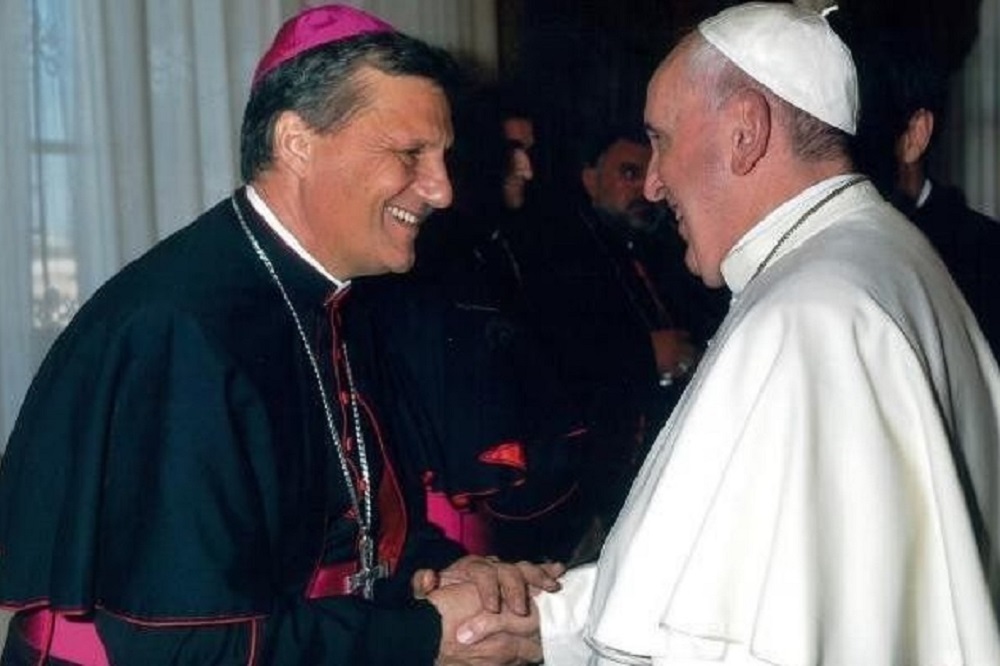 Cardeal Mario Grech e Papa Francisco em cumprimento de mãos, ambos sorrindo, se olhando, de perfil