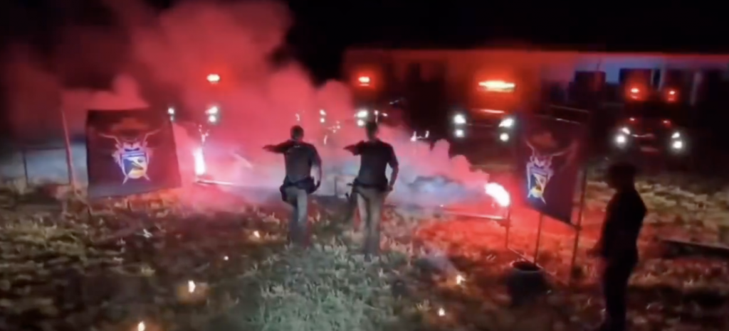 Policiais de São José do Rio Preto em frente a uma cruz em chamas e fazendo gestos semelhantes aos de grupos nazistas