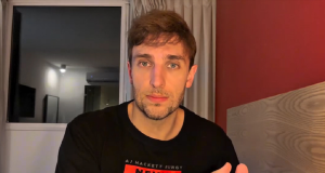 Léo Lins de camiseta preta, olhando sério para a câmera