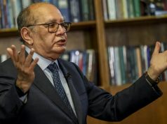 ministro do STF Gilmar Mendes com os braços abertos, falando