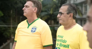 Jair Bolsonaro e Silas Malafaia lado a lado, sérios, em pé, com camisetas verde e amarelas