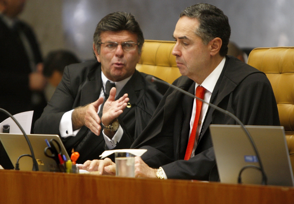 O ministro Luiz Fux e o presidente do Supremo Tribunal Federal (STF), Luís Roberto Barroso, sérios, lado a lado