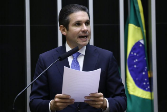 Hugo Motta (Republicanos-PB) falando em microfone e segurando papel