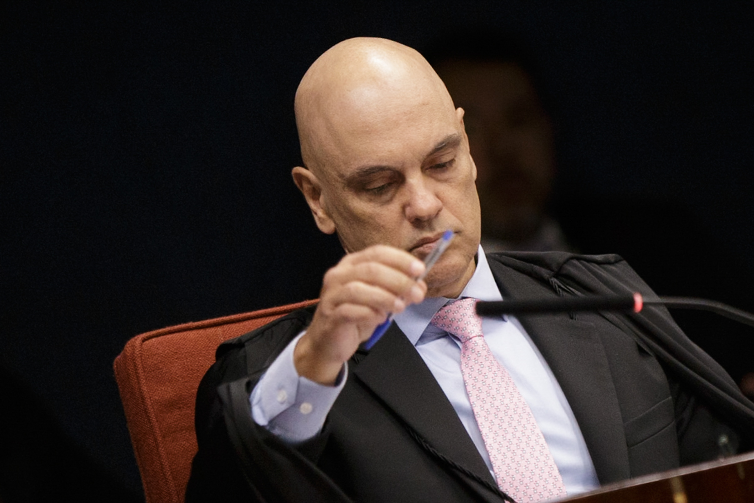 O ministro Alexandre de Moraes, do STF (Supremo Tribunal Federal), sério, segurando caneta