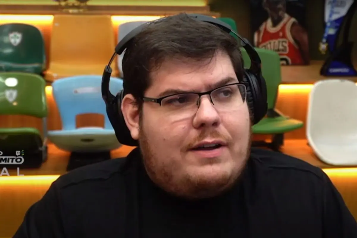 Casimiro Miguel de fones de ouvido, olhando para o lado, sério