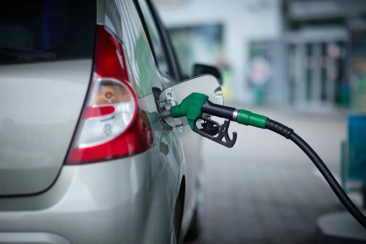 Carro prata sendo abastecido