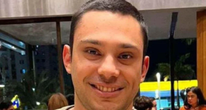 O brasiliense Lucas Marques Vilela em close, de camiseta bege, sorrindo para a câmera