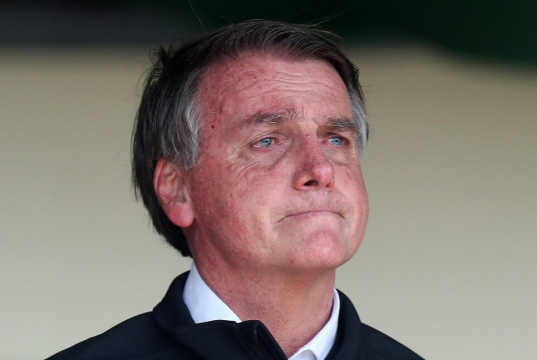 Jair Bolsonaro com cara de choro, sem olhar para a câmera
