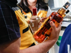Pessoas segurando garrafas de bebida alcoólica