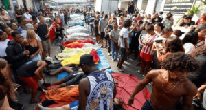 Corpos enfileirados após operação policial com pessoas em volta