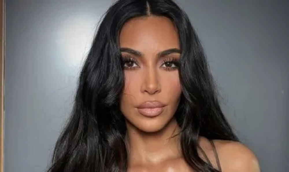 Kim Kardashian olhando para a câmera, séria, de cabelo solto