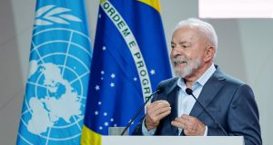 Presidente da República, Luiz Inácio Lula da Silva, falando em microfone e gesticulando, olhando para o lado