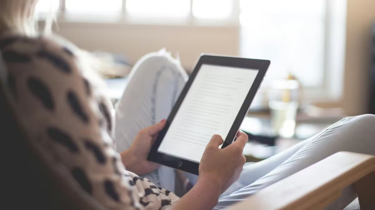 Mulher sentada com tablet na mão