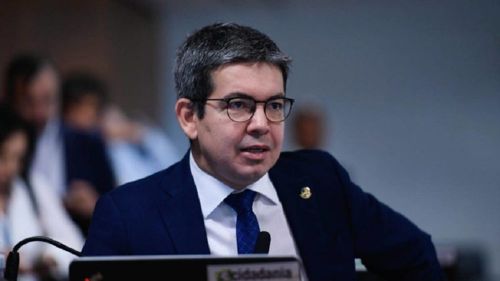 senador Randolfe Rodrigues (PT-AP) falando, sem olhar para a câmera, de óculos