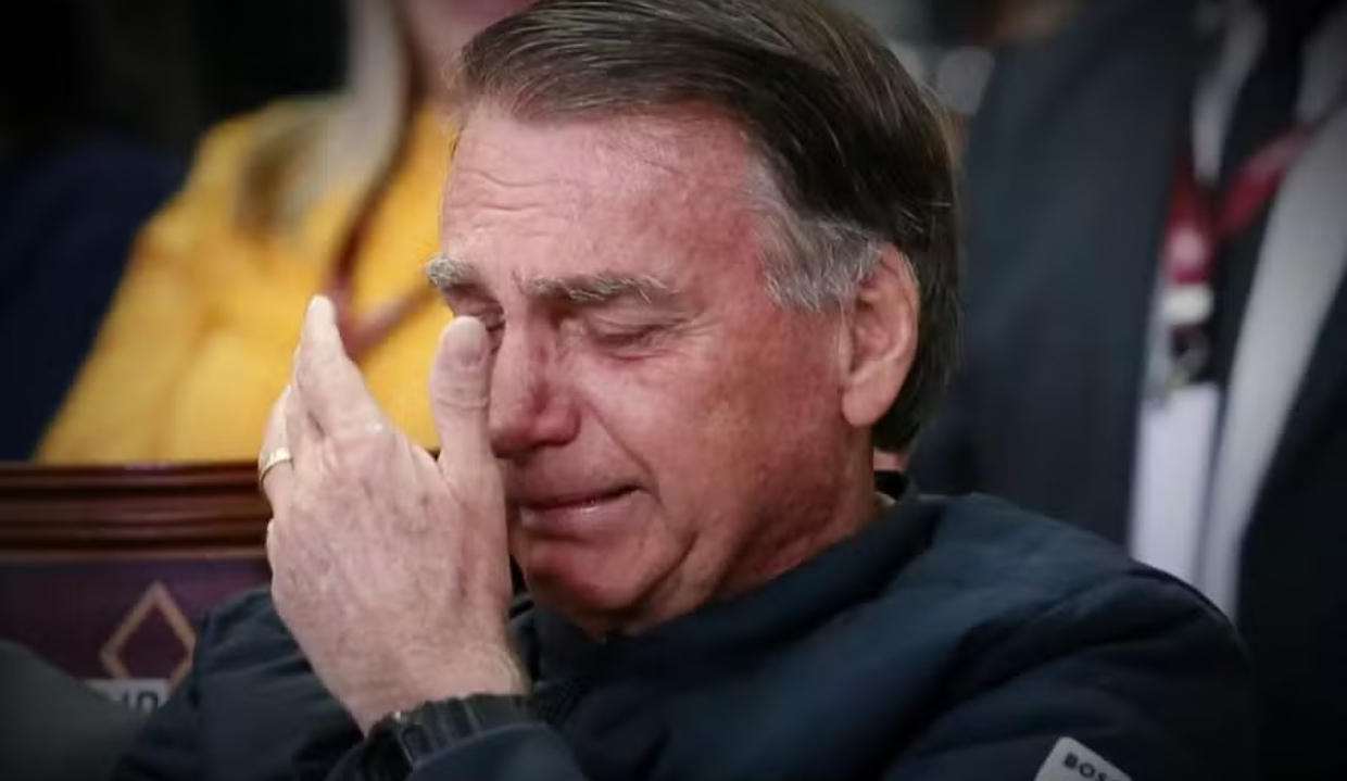 Jair Bolsonaro chorando com a mão no rosto