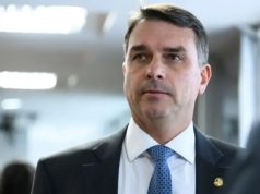 O senador Flávio Bolsonaro (PL) com expressão pensativa, sem olhar para a câmera