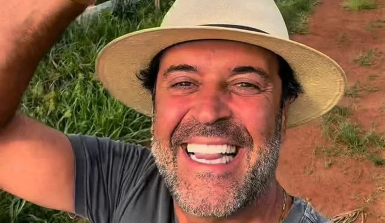 O influenciador Henrique Maderite em close, sorrindo para selfie, de chapéu